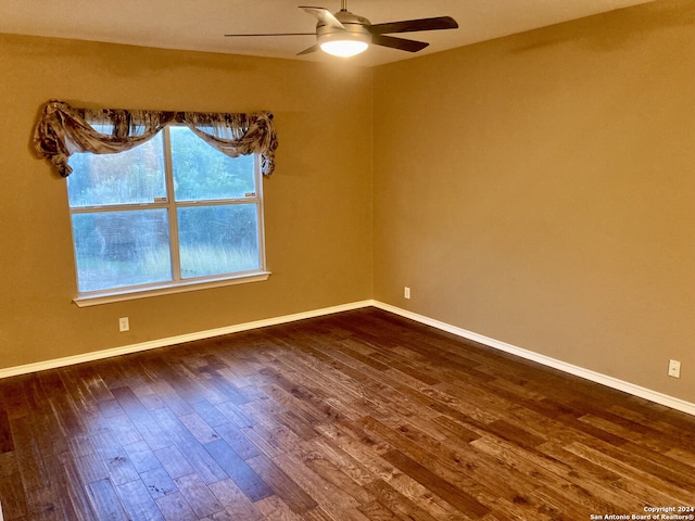 unfurnished room with ceiling fan and dark hardwood / wood-style floors