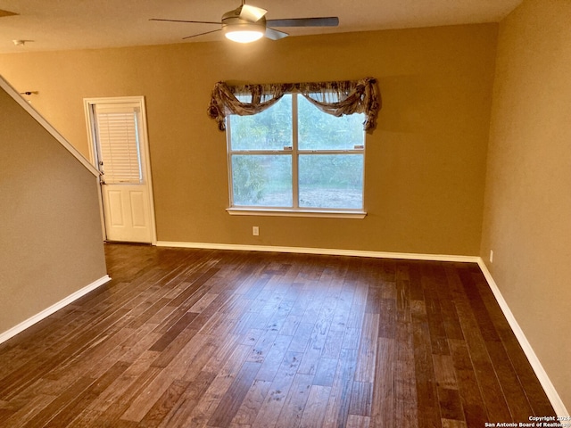 spare room with dark hardwood / wood-style floors and ceiling fan