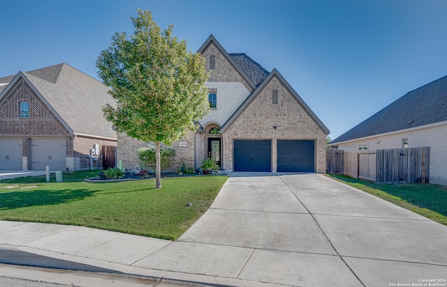 view of front of house with a front yard and a garage