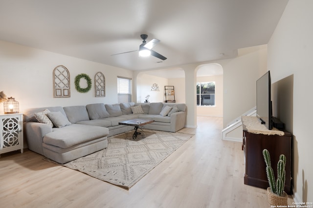 living room with ceiling fan and light wood-type flooring