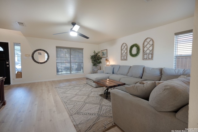 living room with ceiling fan and light wood-type flooring