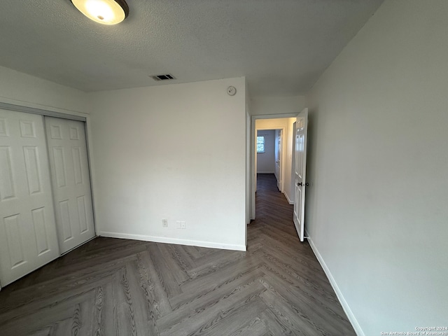 unfurnished bedroom featuring a closet and a textured ceiling