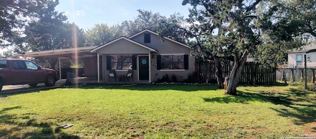 bungalow-style home featuring a front lawn and a carport