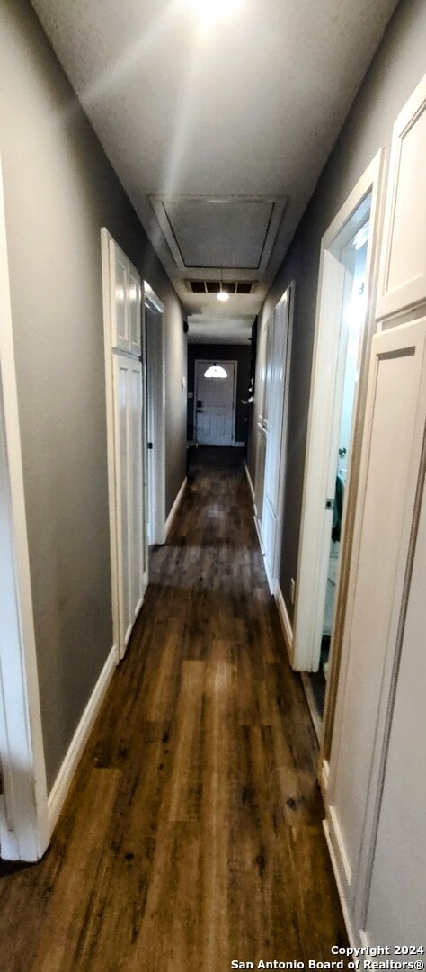 corridor with dark hardwood / wood-style floors