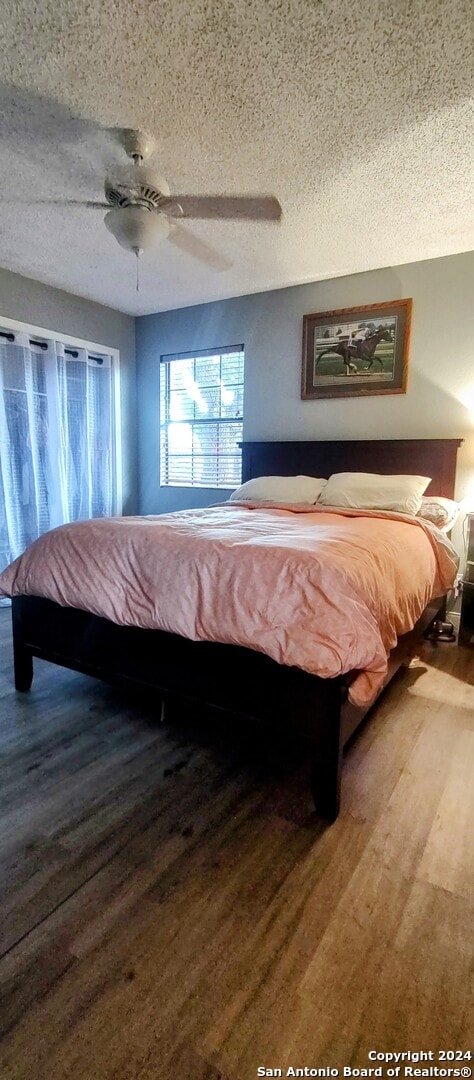 unfurnished bedroom featuring hardwood / wood-style floors, a textured ceiling, and ceiling fan