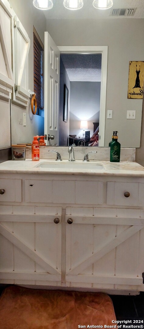 bathroom featuring vanity and a textured ceiling