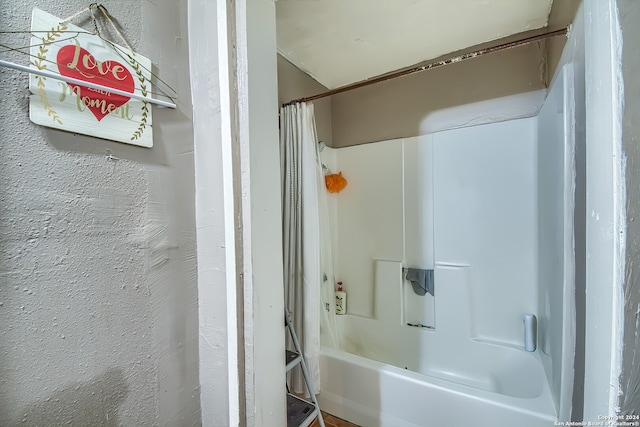 bathroom with shower / bathtub combination with curtain