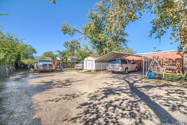 exterior space featuring a storage unit and a carport