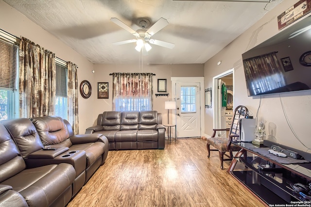 living room featuring hardwood / wood-style flooring and ceiling fan