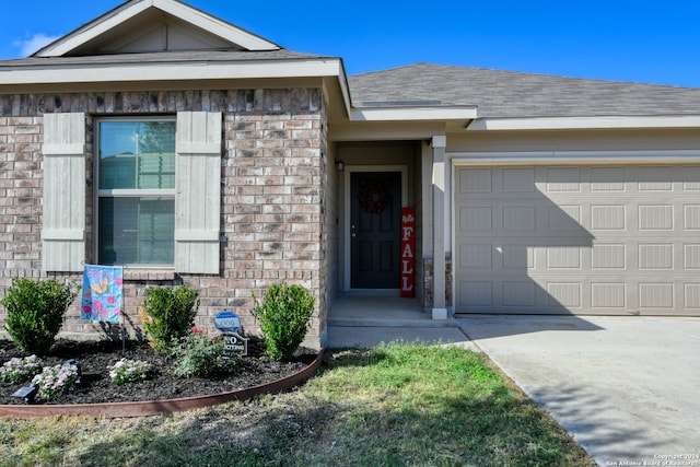 view of exterior entry featuring a garage