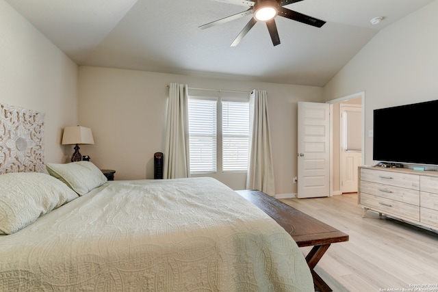 bedroom featuring ceiling fan, vaulted ceiling, and light hardwood / wood-style flooring