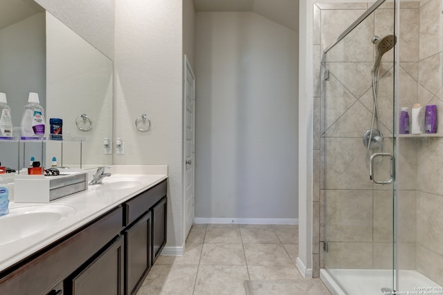 bathroom featuring tile patterned floors, vanity, a shower with shower door, and lofted ceiling