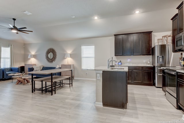 kitchen with a wealth of natural light, sink, vaulted ceiling, and appliances with stainless steel finishes