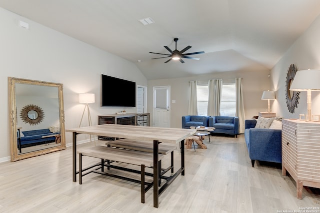 living room featuring ceiling fan, light wood-type flooring, and lofted ceiling