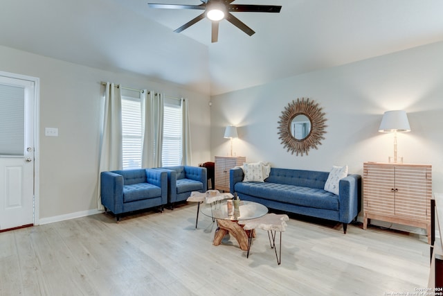 living room with light hardwood / wood-style floors, vaulted ceiling, and ceiling fan