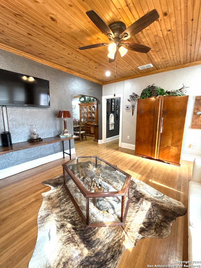 living room featuring ornamental molding, light hardwood / wood-style floors, ceiling fan, and wooden ceiling