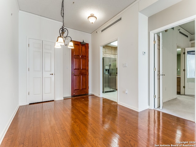 interior space featuring a chandelier, a textured ceiling, and hardwood / wood-style flooring