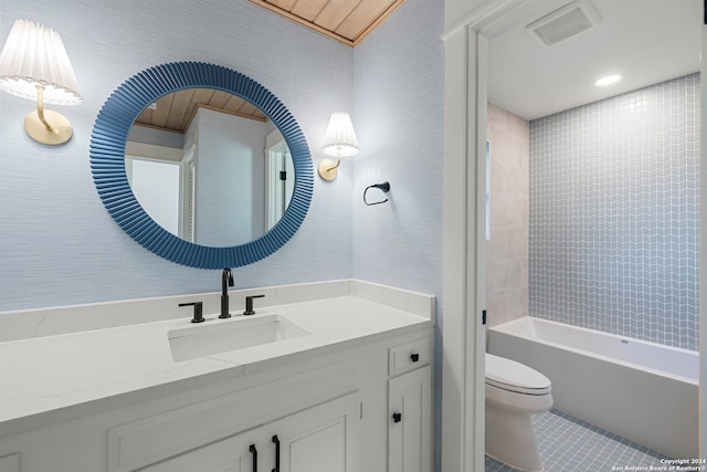 full bathroom featuring tiled shower / bath, tile patterned floors, vanity, and toilet