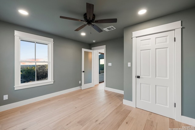 unfurnished bedroom featuring ceiling fan and light wood-type flooring