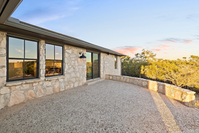 back house at dusk with a patio