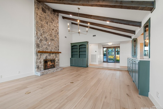 unfurnished living room with a stone fireplace, beamed ceiling, high vaulted ceiling, a chandelier, and light hardwood / wood-style floors