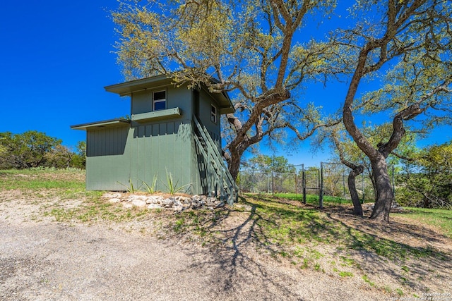 view of side of home with fence