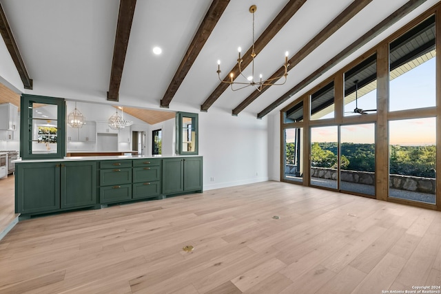 unfurnished living room with beam ceiling, plenty of natural light, ceiling fan with notable chandelier, and light hardwood / wood-style flooring