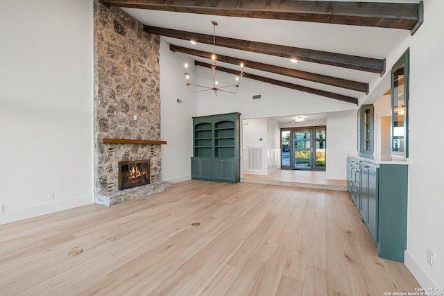 160 Mountain Way, Kerrville, TX 78028 - unfurnished living room with light wood finished floors, beam ceiling, a chandelier, a stone fireplace, and baseboards
