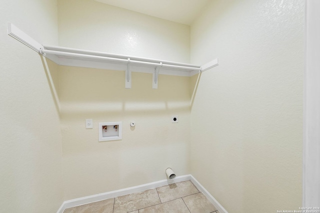 washroom featuring electric dryer hookup, hookup for a gas dryer, hookup for a washing machine, and light tile patterned floors