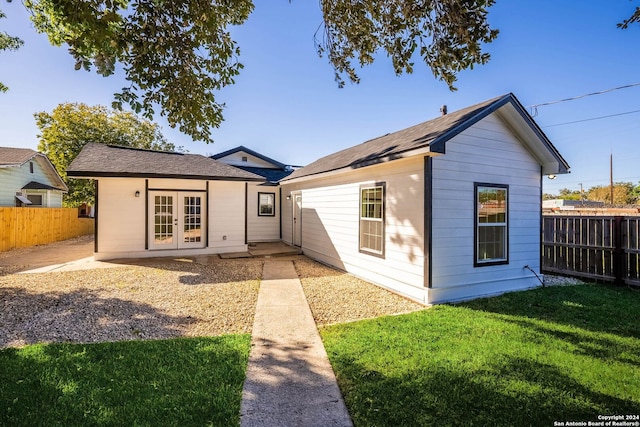 rear view of property with a yard and french doors