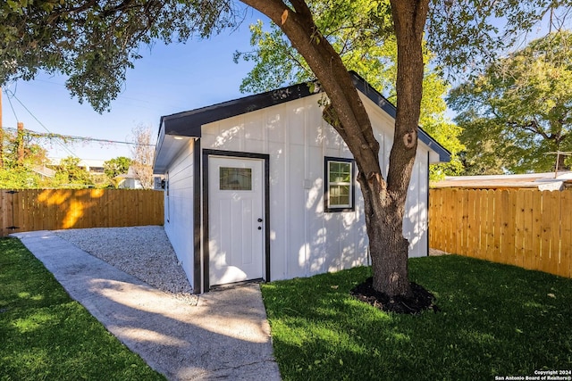 view of outbuilding with a yard