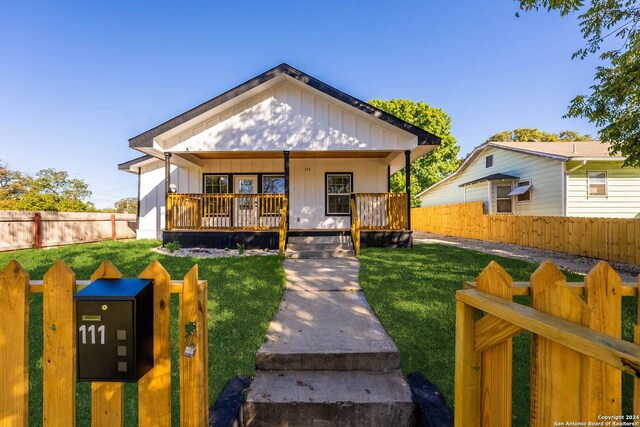 bungalow with a front lawn and a porch