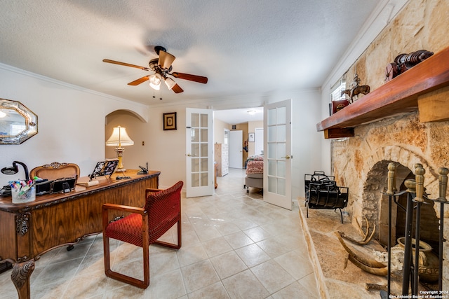 office area featuring ceiling fan, french doors, a textured ceiling, and ornamental molding