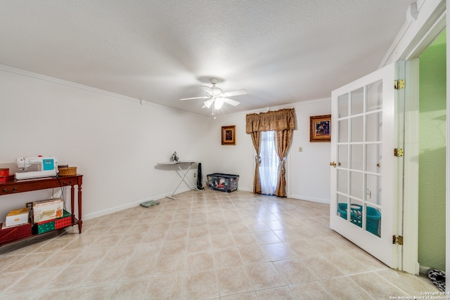 interior space with french doors, a textured ceiling, ceiling fan, and crown molding