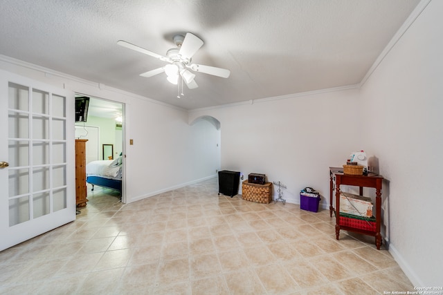 miscellaneous room featuring a textured ceiling, ceiling fan, and crown molding