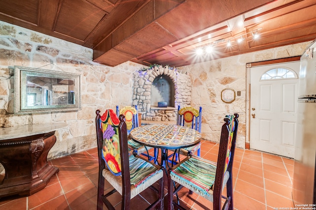 tiled dining area featuring wood ceiling