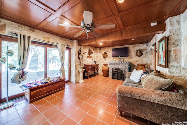 living room with tile patterned floors, ceiling fan, wooden ceiling, and coffered ceiling