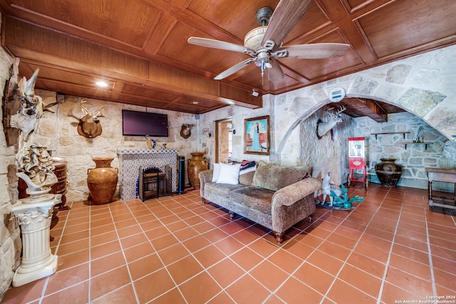 living room featuring tile patterned flooring, ceiling fan, beamed ceiling, and wood ceiling