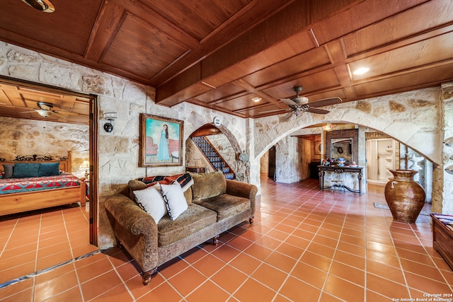 living room featuring beamed ceiling, tile patterned floors, ceiling fan, and wooden ceiling