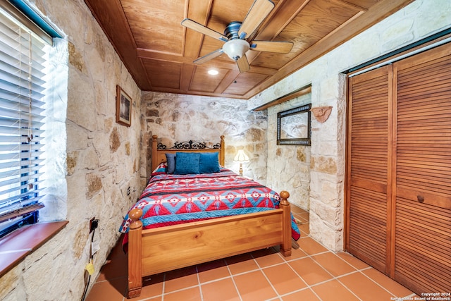 bedroom featuring a closet, tile patterned floors, ceiling fan, and wooden ceiling