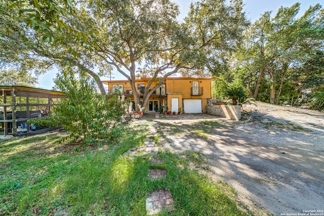 view of front of home with a garage and a sunroom