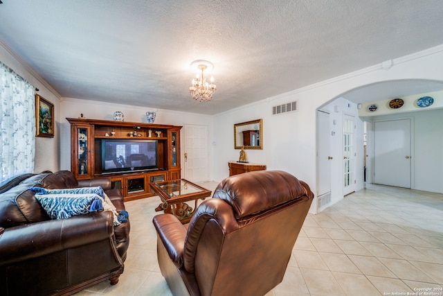 living room featuring a chandelier, light tile patterned floors, a textured ceiling, and crown molding