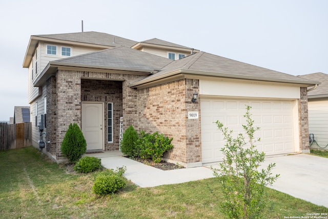 view of front of house featuring a garage and a front lawn