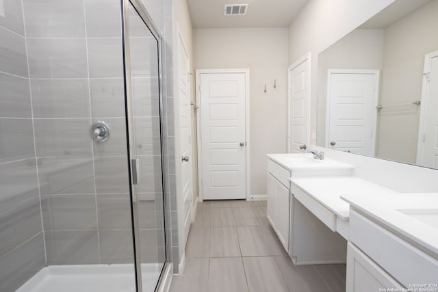 bathroom with vanity and a shower with shower door