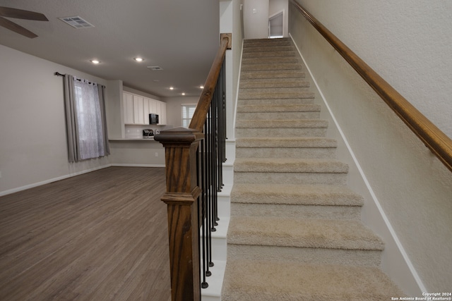 stairway featuring hardwood / wood-style flooring