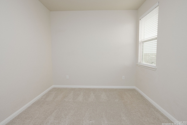 spare room with light carpet