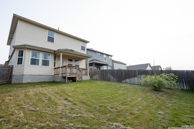 rear view of house with a lawn