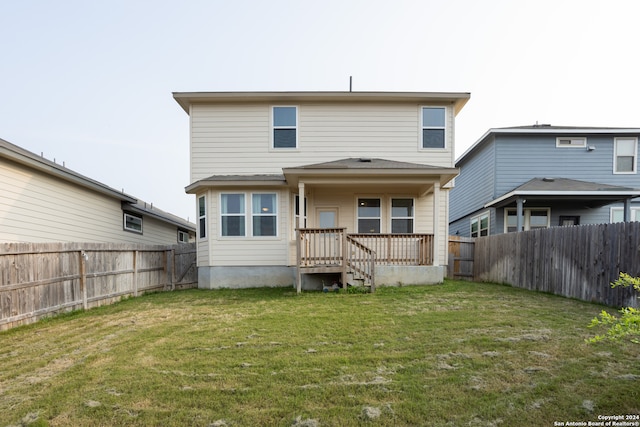 rear view of property with a lawn