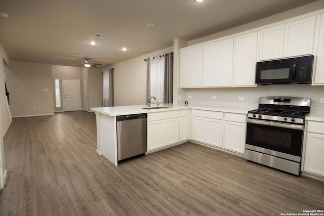 kitchen featuring kitchen peninsula, ceiling fan, light wood-type flooring, white cabinetry, and stainless steel appliances