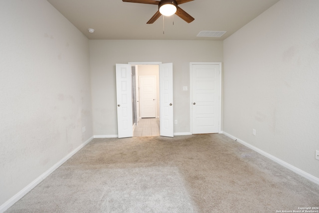 unfurnished bedroom with light carpet and ceiling fan